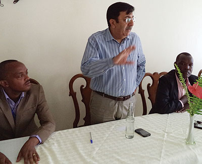 Anand (middle) addresses customers in Huye on Friday. The banker says growing demand for loans will boost growth. The New Times / JP Bucyensenge  