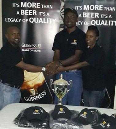 Kigali Golf Club captain and lady captain receive kits from Frank Tumwine, (L) the EABL Area  Sales Manager for Rwanda on Friday. Saturday Sport/ Courtesy.