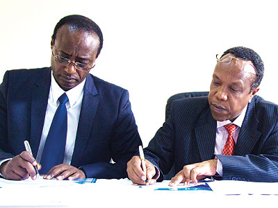 Prof. Manasseh Nshuti (L), one of the founders of University of Kigali, and Dr. George Njenga, the vice-chancellor and dean of Strathmore Business School sign a memorandum of un....
