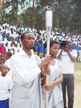 Muhanga students, Jean-Marie Vianney Uwishema  and Jacqueline Niyonsenga received the Flame as it arrived in Muhanga on Thursday.    Jean Pierre Bucyensenge.