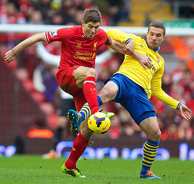 Liverpoolu2019s captain Steven Gerard nips the ball away from Arsenal striker Lucas Podolski during last weekendu2019 Premier League encounter at Anfield. Net photo