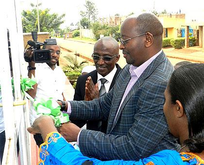 Minister James Musoni cutting a ribbon at the inauguration. Stephen Rwembeho