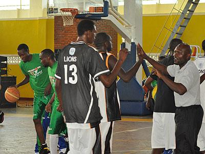 APR's Kenyan coach Cliff Owuor, right, gives hi-fives to his players before the start of Game Three of the 2012 Playoffs game against Espoir. File
