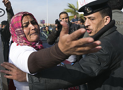 Deposed Egyptian President Mohammed Morsi supporter shouts slogans outside the Police Academy in Cairo where the ousted leader arrived in Cairo for a trial. Xinhua