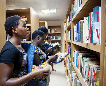 Students checking through books at Kigali Public Library. Senate has approved a Bill setting up  Rwandan Archives and Library Authority.   T.Kisambira