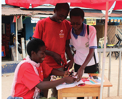 An airtel money dealer serves a customer. Mobile money transfer services have greatly expanded over the past year. The New Times / File