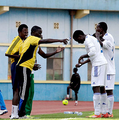 Camarade Banamwana (left) pours water on one of his players during a previous league game against Rayon Sports. File