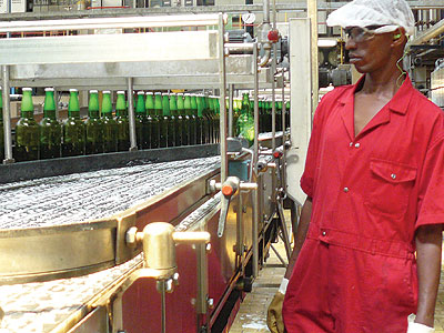 A worker at Bralirwa supervises the production process. Standards body has directed brewers to start using glass bottles like these from May 1. John Mbanda