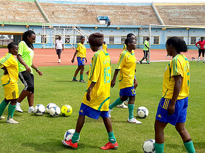 She-Amavubi coach, Grace Nyinawumuntu, (left with dreadlocks), taking her team through a trainig session last week at Amahoro sSadium. Courtesy