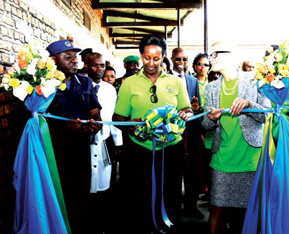 The First Lady, Jeannette Kagame, cuts the ribbon to launch the Isange One Stop Centre at Nyagatare Hospital yesterday, with the help of IGP Emmanuel Gasana and the Dutch Ambassado....