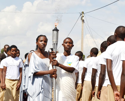 The Kwibuka Flame on its arrival in Burera town carried by two 20-year-olds. Jean du2019Amour Mbonyinshuti.