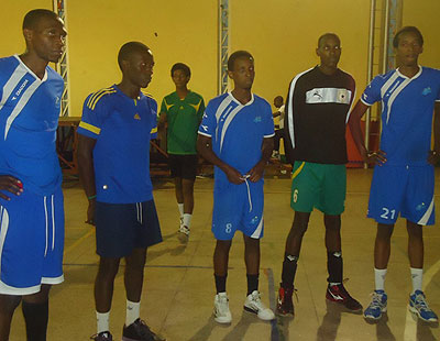 Some of Rayon Sports' players listening to their coach Fidele Nyirimana (below),   during a training session. File