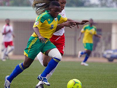 She-Amavubi striker Anne-Marie Ibangarye battling past Kenyan defender during the first leg match at Stade de Kigali two weeks ago. John Mbanda.