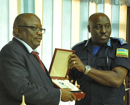 IGP Emmanuel K. Gasana exchanging gifts with his Namibian counterpart, Lt. Gen. S.H. Ndeitunga. Courtesy