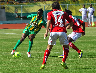 Haruna Niyonzima rounds off Al Ahly players in Saturday's Africa Champions league clash. Young Africans won the tie 1-0 in Dar es Salaam.