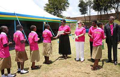 The First Lady, Jeannette Kagame, hands out certificates to some of the best performing school girls. On her immediate left is the Unicef country representative, Noala Skinner. Vil....