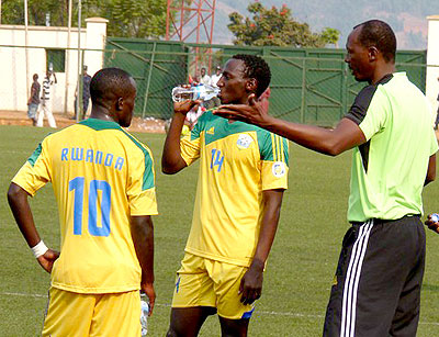 Eric Nshimiyimana, (right), talking to his players during a training session at Stade de Kigali.
