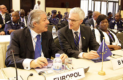  Europol Deputy Director Operations Michel Quill (L) chats with another delegate at the conference on Monday. John Mbanda.  