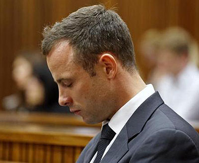 Olympic and Paralympic track star Oscar Pistorius sits in court during the fifth day of his trial for the murder of his girlfriend Reeva Steenkamp at the North Gauteng High Court i....