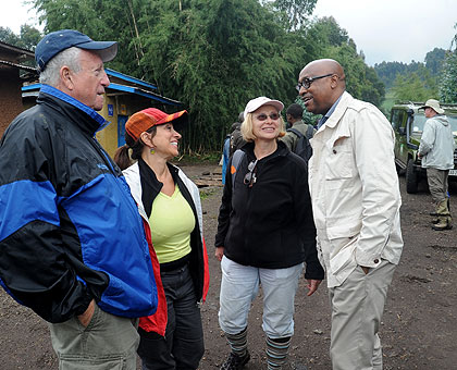 Joseph Birori (R), the Managing Director of Primate Safaris, chats with tourists just outside Virunga National Park last year. Tour operators are optimistic that the recognition of....