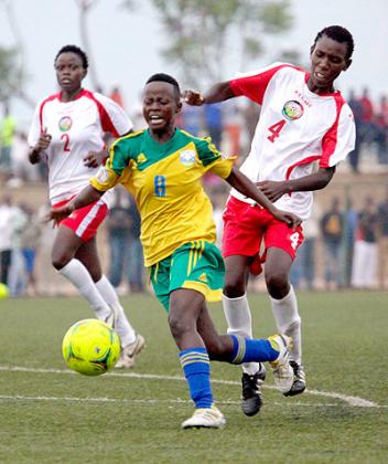 She-Amavubi star striker Shadia Uwamahirwe, seen above going to the ground after being clipped from behind by a Kenyan defender. T. Kisambira