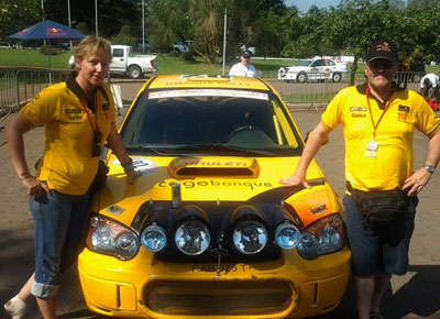 READY TO GO; Giancarlo Davite, right and his navigator Sylvia Vindevogel, left, pose in-front of their Subaru Impreza N12  yesterday in in Yamoussoukro. Courtsey