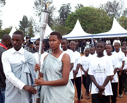 The Kwibuka Flame is carried to Kiziguro in the eastern district of Gatsibo on Thursday. Jean Pierre Bucyensenge.