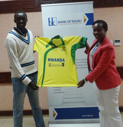 Bank of Kigali's Shivon, right hands over playing attire to national team captain Eric Dusingizimana at the bank's headquarters . Courtesy.