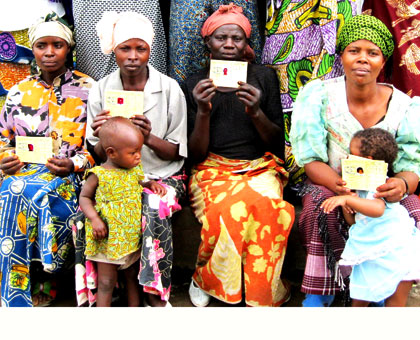 Women pose with their Mutuelle de Sante cards. Private insurance firms have expressed mixed feelings over the government's plan to increase health insurance premium from the curren....