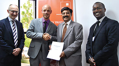 Andreas (second, left) and Anantapur (second, right) and other bank officials after the signing of partnership deal on Friday. The New Times /  Courtesy photo