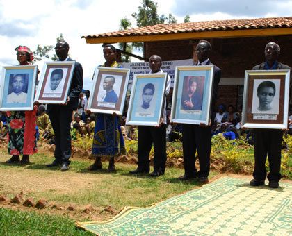 Parents and Nyange Massacre survivors hold the  portraits  of  the students killed by the Interahamwe militia after they refused to divide themselves along ethnic lines. Hyppolite ....