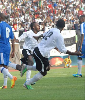 Charles Tibingana, center, and Jean-Claude Iranzi celebrating after the formeru2019s goal against Rayon Sports in November 2013. File Photo