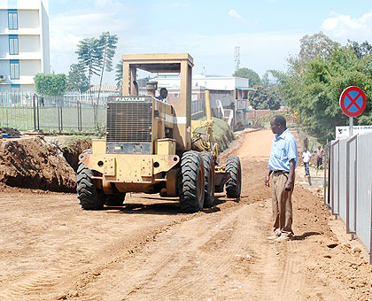 Contractors level the surface of a road under construction in Kimihurura. (File)