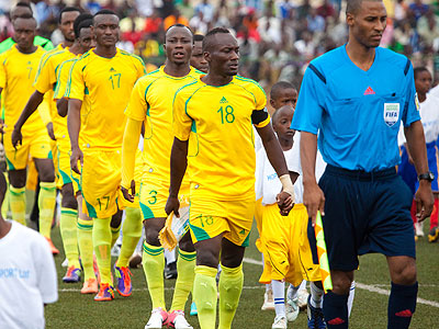  AS Kigali skipper Jimmy Mbaraga (#18) leads his teammates onto the field on Saturday for the first leg clash at the Kigali Regional Stadium. (Timothy Kisambira)