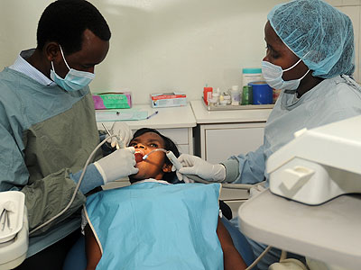 Dentists attend to a patient at Kigali Health Institute in 2012. (John Mbanda)