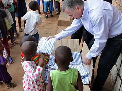 Marc Holtzman distributes pajamas to children at Gisimba orphanage in Kigali yesterday. (John Mbanda)