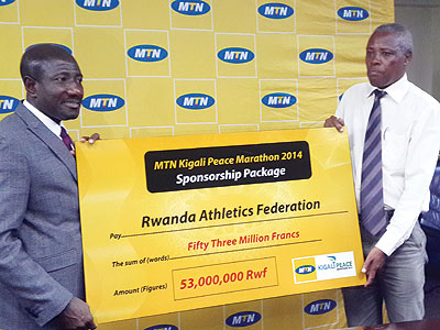 MTN Rwanda CEO Ebenezer Twum Asante (left) hands over the Rwf53m cheque to the Rwanda Athletics Federation president Jean-Damascu00e8ne Nkezabo. (Courtesy)