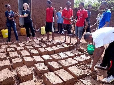 Youth make bricks for Mukarusasau2019s house. (Jean de la Croix Tabaro)