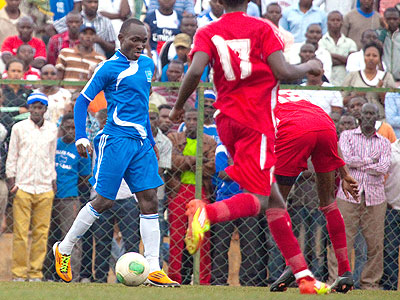 Striker Cedric Amissi tries to dribble past Etincelles defenders. He scored a brace to take his goal tally to 12 this season. (Timothy Kisambira)
