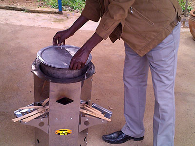 A man shows how a u2018Save80u2019 cooking stove is used. (Athan Tashobya)