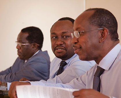 John Gara, the chairperson of the National Law Reform Commission (R) chats with Minister Imena. Left is Michael Biryabarema, deputy director-general of Geology and Mines Department....