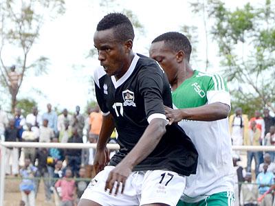 APR midfielder Charles Tibingana shielding the ball from SC Kiyovuu2019s Celestin Habyarimana during yesterdayu2019s match. (Sam Ngendahimana)