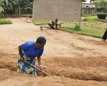 Mukandanga participates in the special community work to extend water to her compound. (Athan Tashobya)