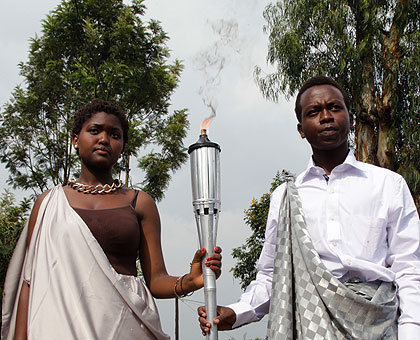 Pascaline Niyigena (L) and Adolphe Gahima carry the Kwibuka Flame from Kigali Genocide Memorial Centre in Gisozi on January 7 shortly after the lighting ceremony. (File)
