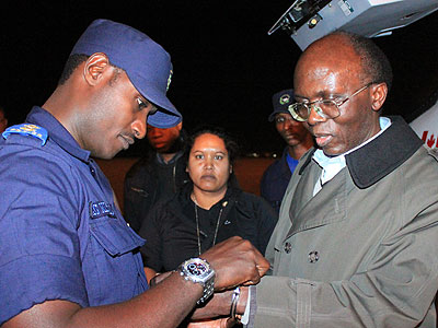 A Rwandan security officer receives Leon Mugesera, a Genocide suspect, upon his extradition from Canada in 2012. (File)