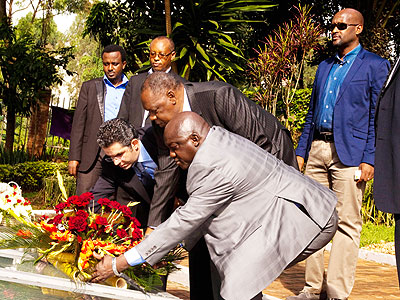 Caf president Issa Hayatou (C), vice president Almamy Kabele Camara (L) and secretary general, Hicham El Amrani (R) lay a wreath in honour of the Genocide victims at the Kigali Mem....
