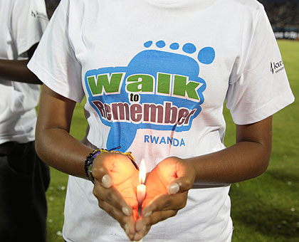 A youngster holds a candle symbolising Rwandau2019s hope despite its brutal past at Amahoro Stadium on Monday. (Timothy Kisambira)