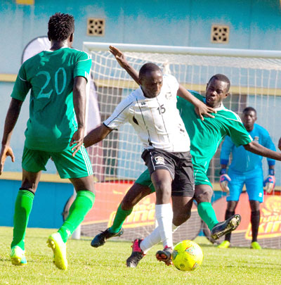 APR midfielder Andrew Buteera, center, tries to beat off a challenge by a Kiyovu opponent during a league match as his team mate Mugiraneza, right looks on. File Photo