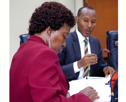 Rwamuganza (R) outlines the revisions to Mukayuhi. Timothy Kisambira.