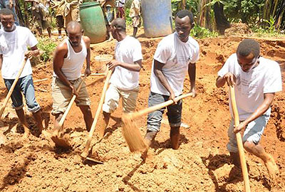 Students digging in one of the gardens they opened for the needy./Susan Babijja 